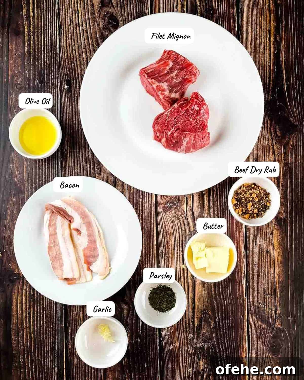 Crispy Bacon-Wrapped Filet Mignon in the Air Fryer 3 The ingredients for the air fryer filet mignon measured out and placed on a wooden table.