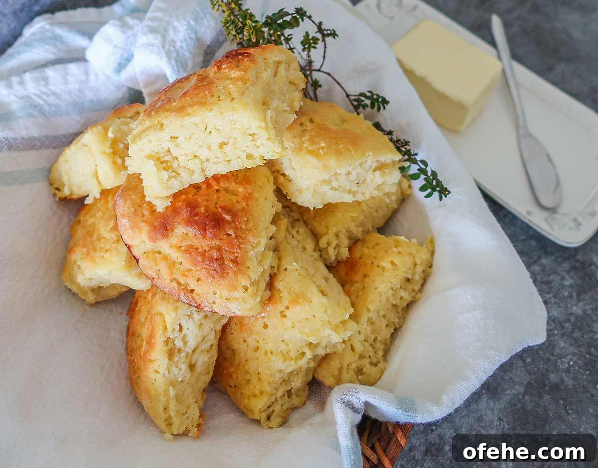 35+ Gluten-Free September Recipes for Seasonal Eating 3 gluten free milk rolls in a towel with butter dish on the side
