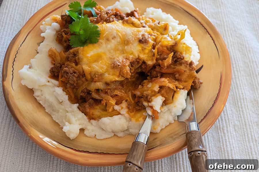 35+ Gluten-Free September Recipes for Seasonal Eating 22 a serving of cheesy cabbage chorizo casserole on a plate