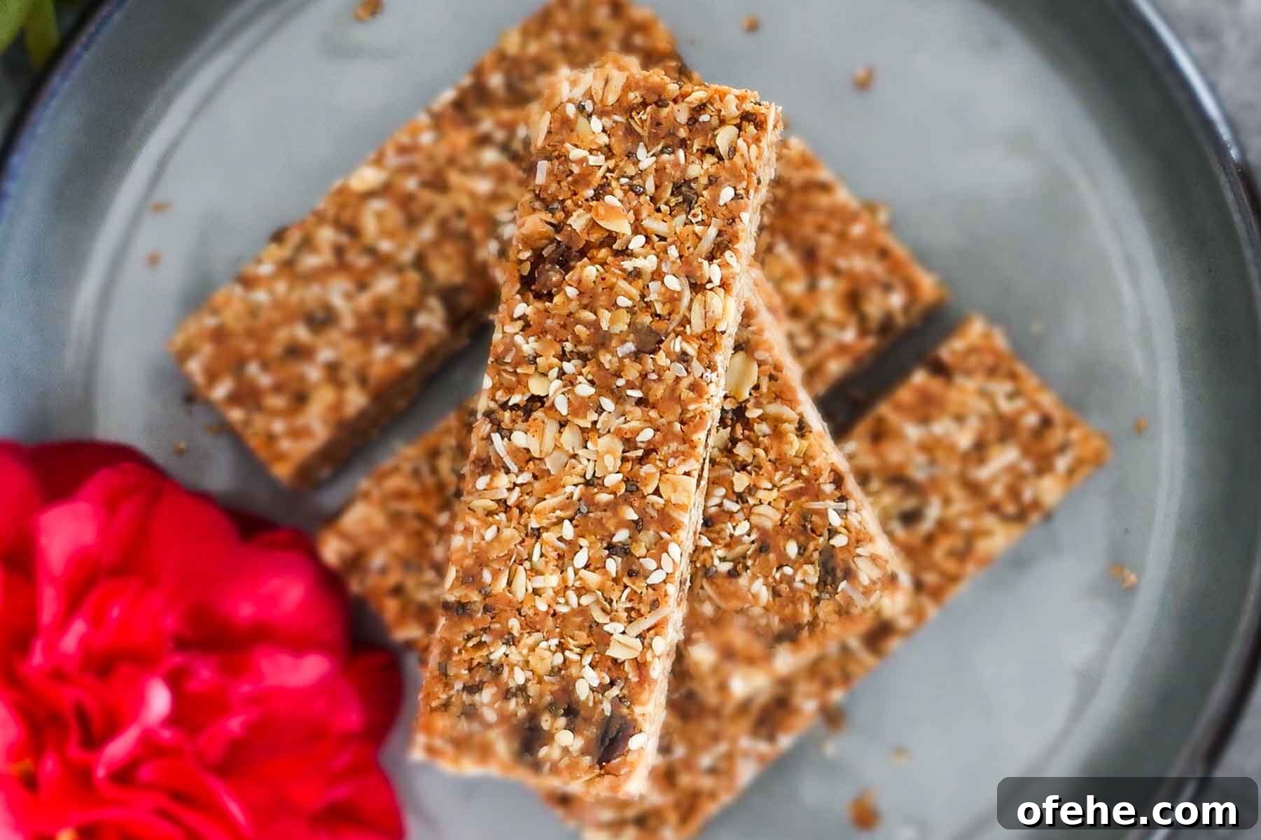35+ Gluten-Free September Recipes for Seasonal Eating 25 gluten free granola bars stacked on a plate with a rose