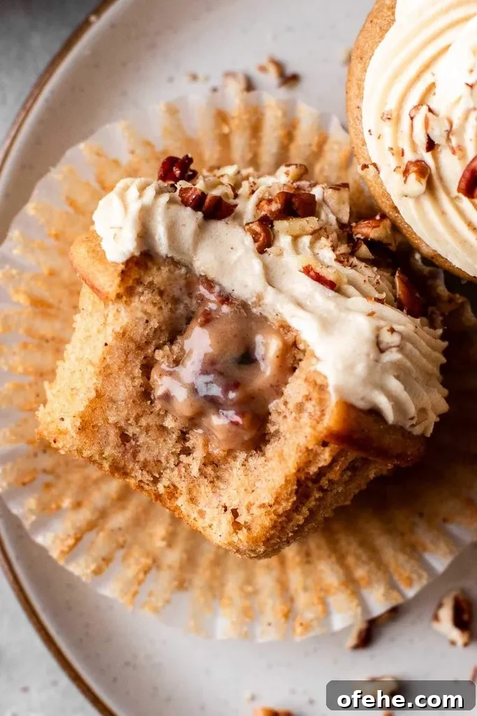 Pecan Pie Cupcakes Recipe — Classic Southern Dessert Cupcakes 15 filled and decorated pecan pie cupcakes in plate with bite missing