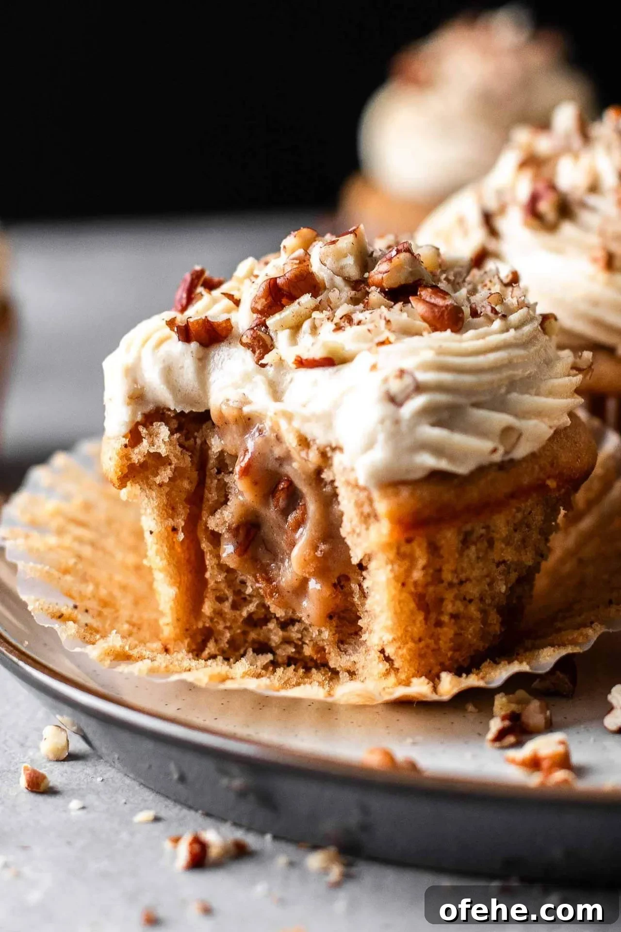 Pecan Pie Cupcakes Recipe — Classic Southern Dessert Cupcakes 3 filled and decorated pecan pie cupcakes in plate with bite missing from one