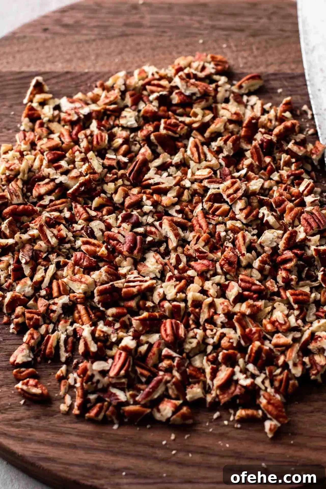 Pecan Pie Cupcakes Recipe — Classic Southern Dessert Cupcakes 4 chopped pecans on cutting board