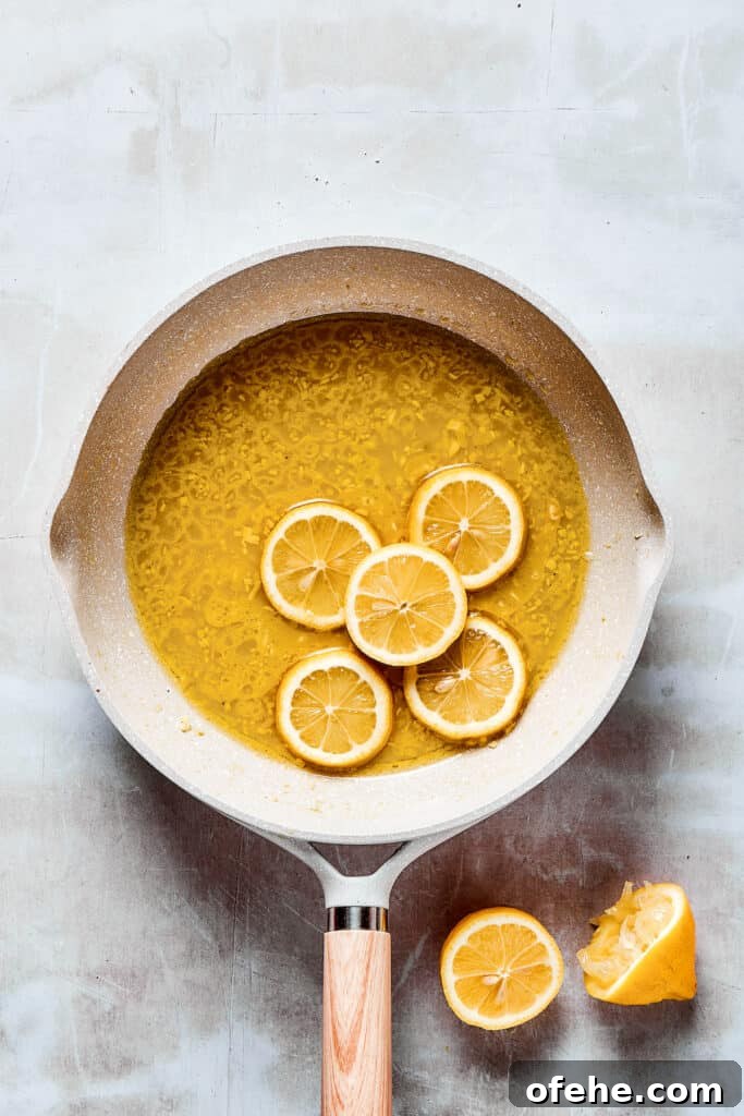 Lemon slices in sauce. Lemon slices added to a skillet of sauce.