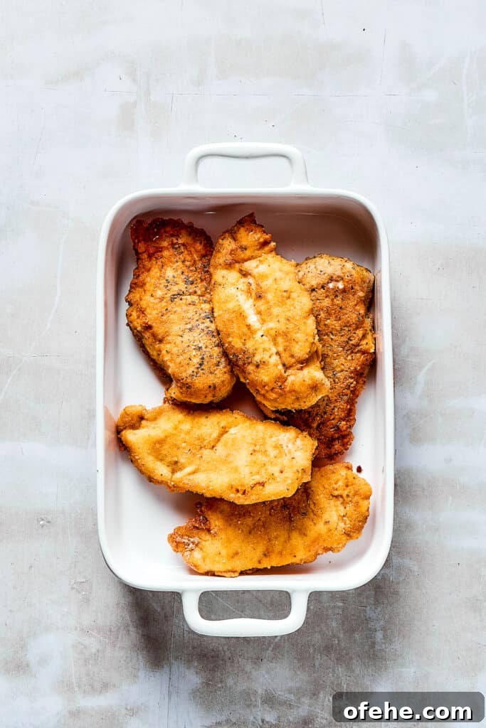 Baked breaded chicken. Breaded, browned chicken in a baking dish.