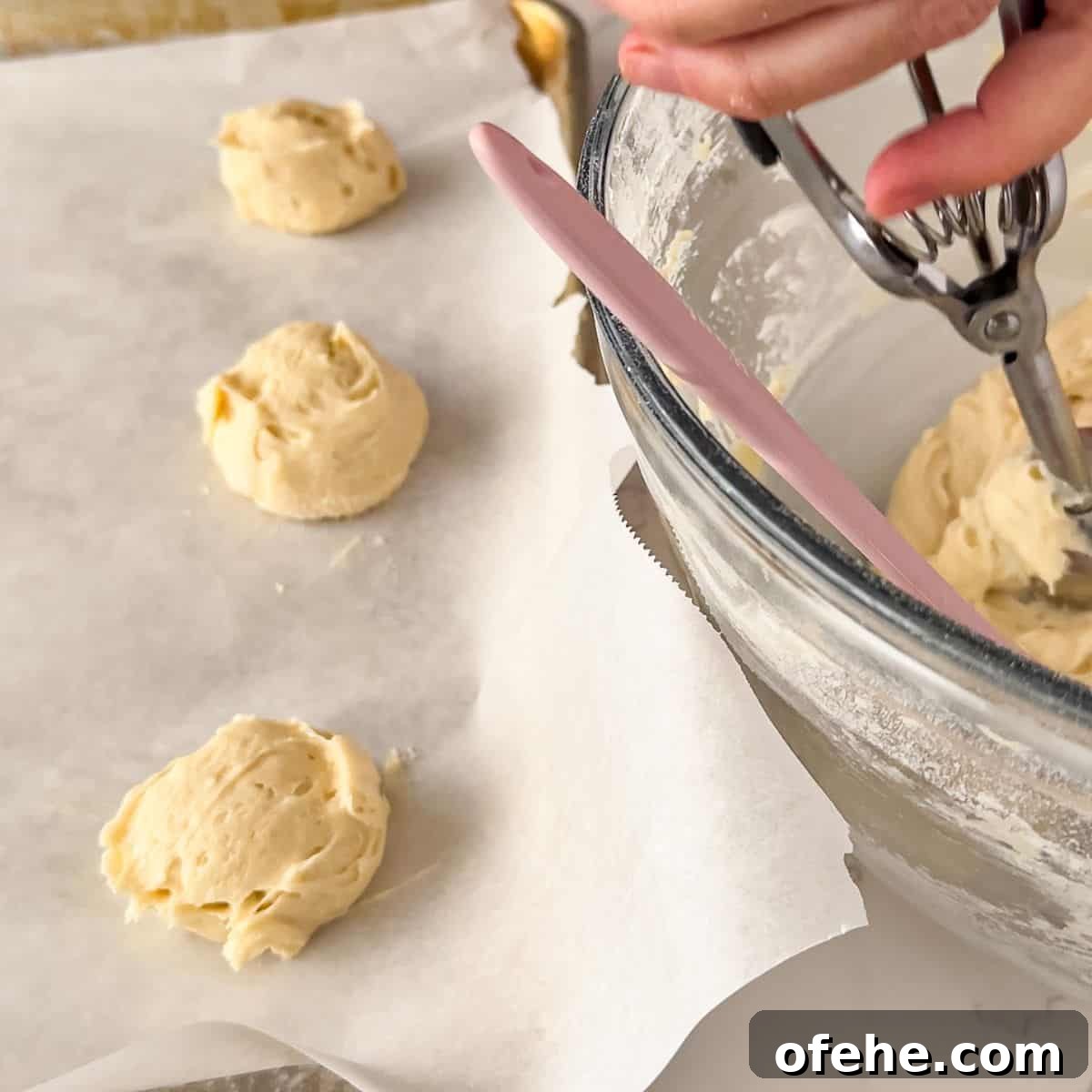 Soft and Creamy Sour Cream Cookies Recipe 7 Scooping the drop cookies.