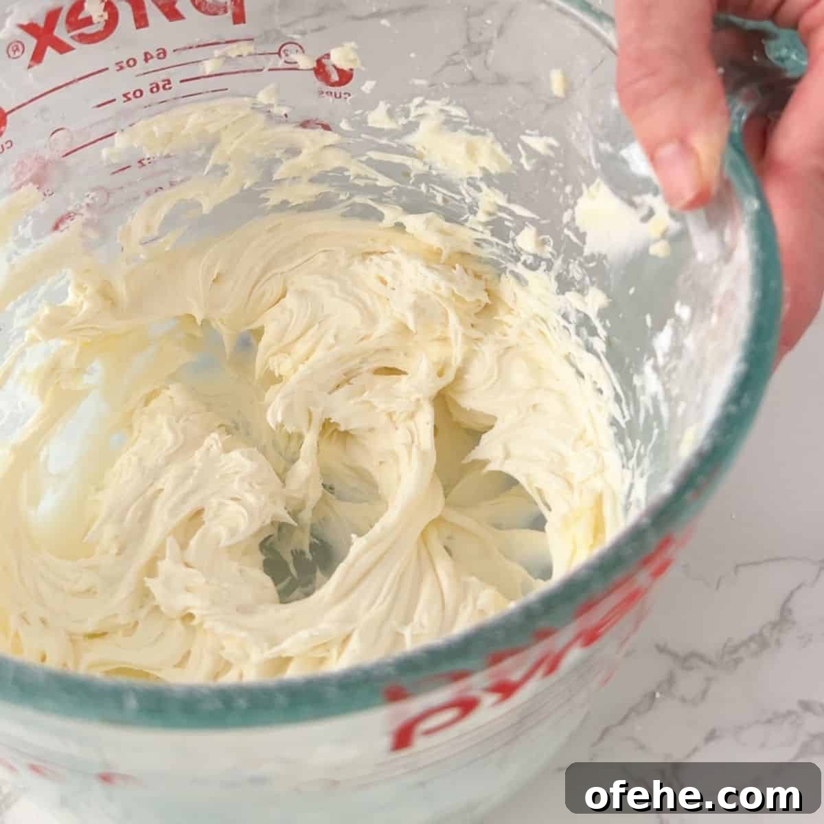 Soft and Creamy Sour Cream Cookies Recipe 9 Adding the powder sugar for frosting.