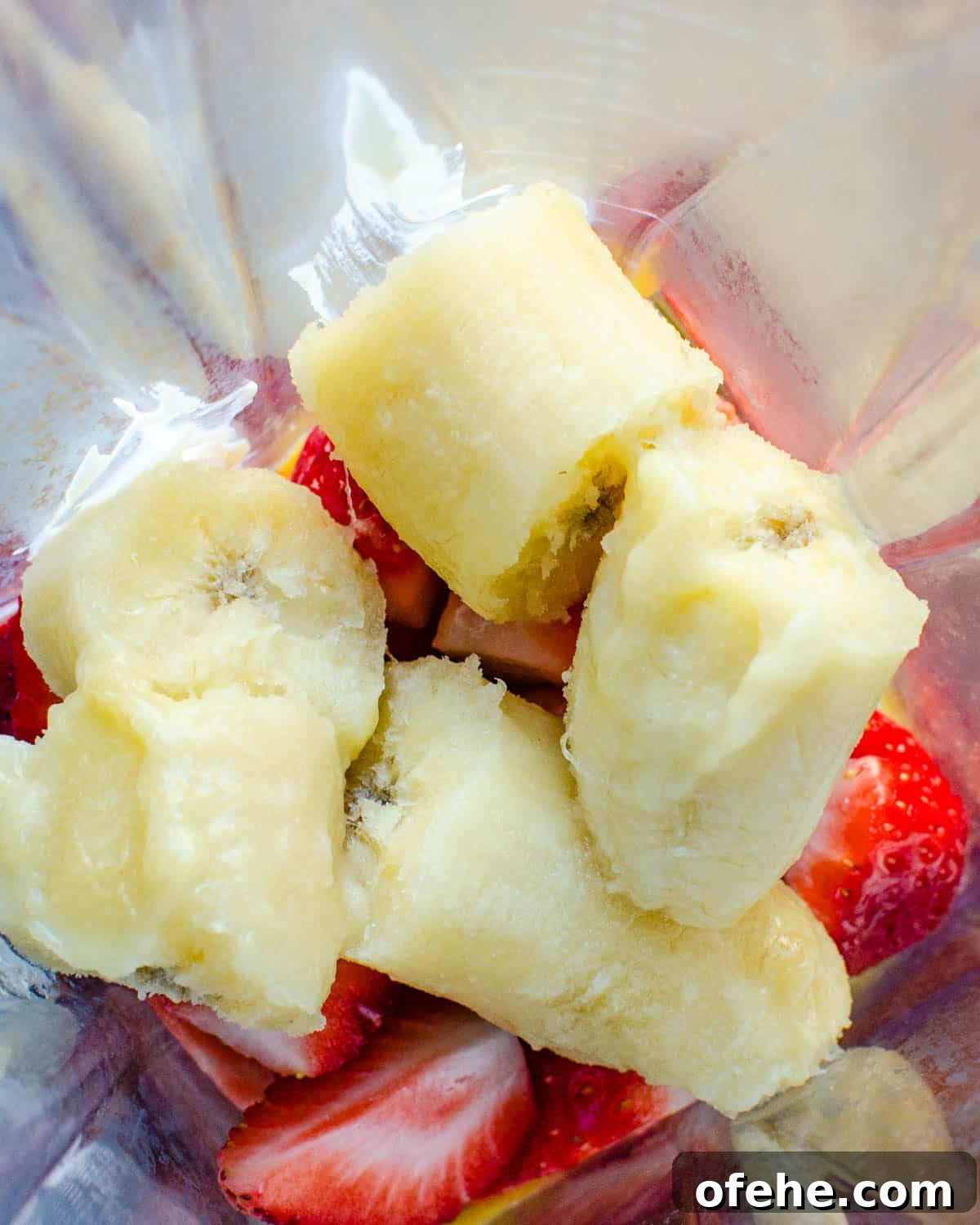 Strawberry Orange Banana Smoothie Recipe for Fresh Morning Energy 4 adding bananas to the blender.