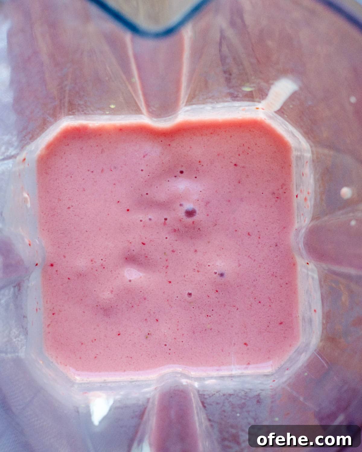 Strawberry Orange Banana Smoothie Recipe for Fresh Morning Energy 5 blending the smoothie.