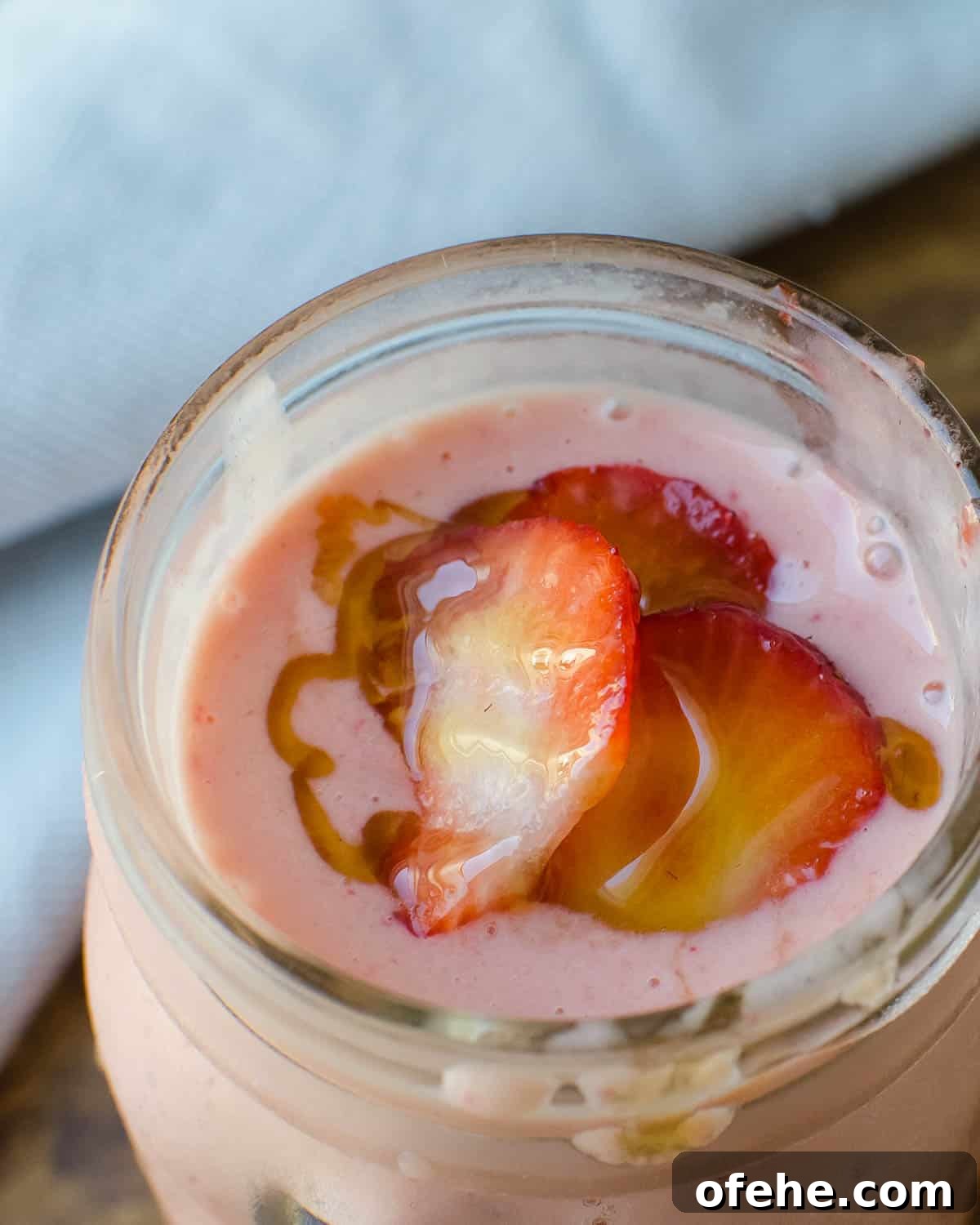 Strawberry Orange Banana Smoothie Recipe for Fresh Morning Energy 7 sipping the smoothie.