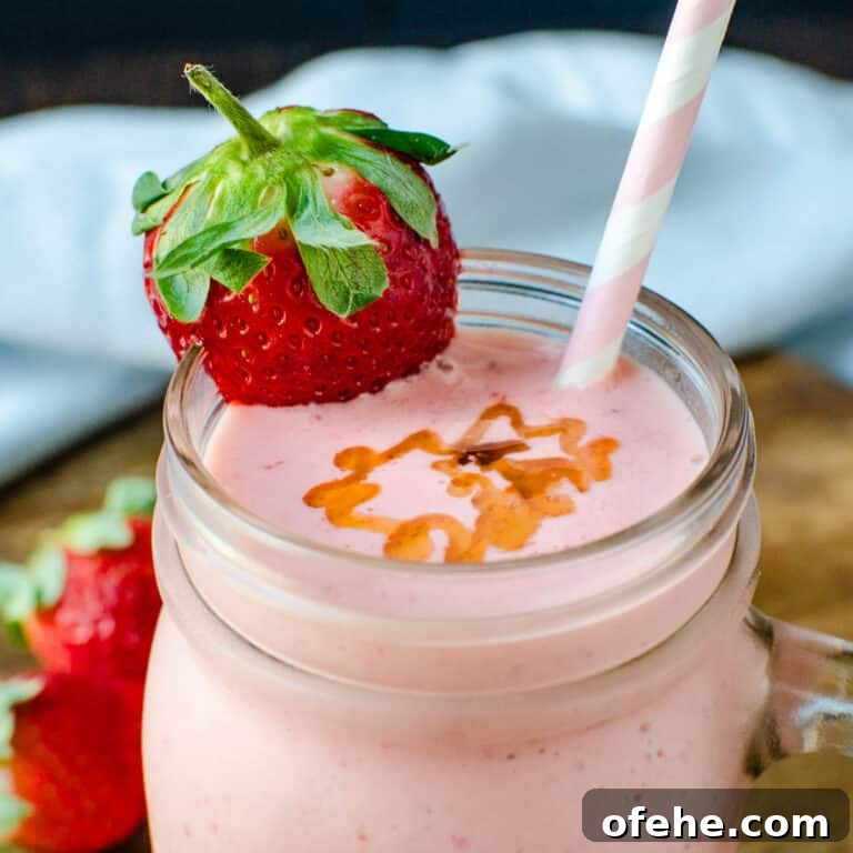 Strawberry Orange Banana Smoothie Recipe for Fresh Morning Energy 8 strawberry orange banana smoothie with a straw.