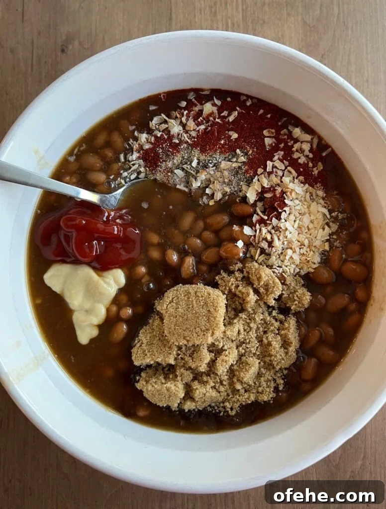 canned beans in casserole dish with brown sugar and spices