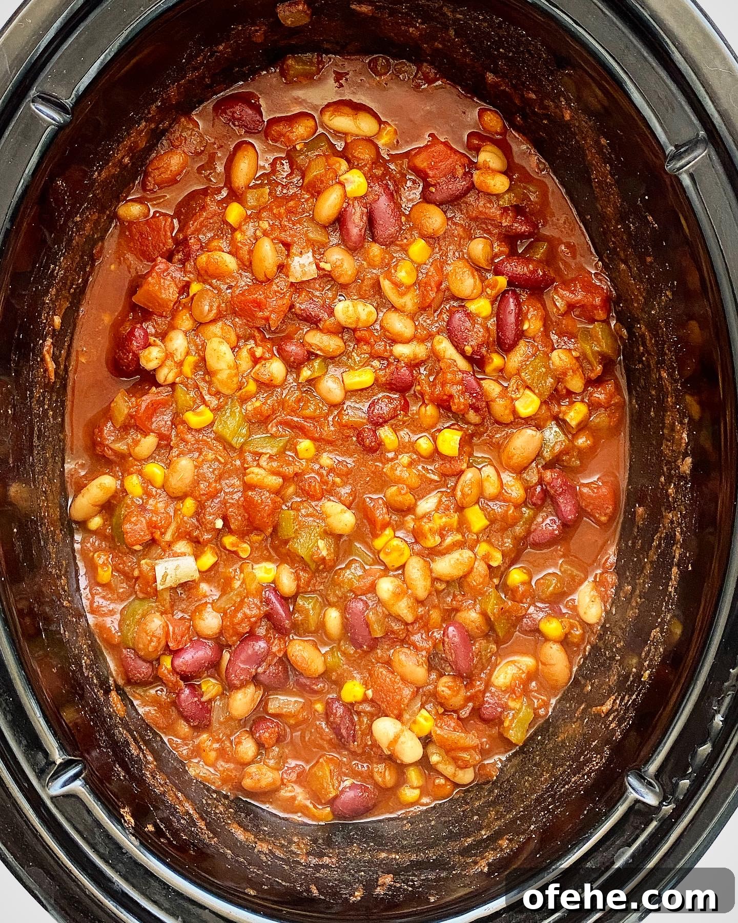 Hearty Crockpot Vegan Chili Recipe for Slow Cooker Success 5 overhead shot of cooked ingredients for the best crockpot vegan chili in a black slow cooker