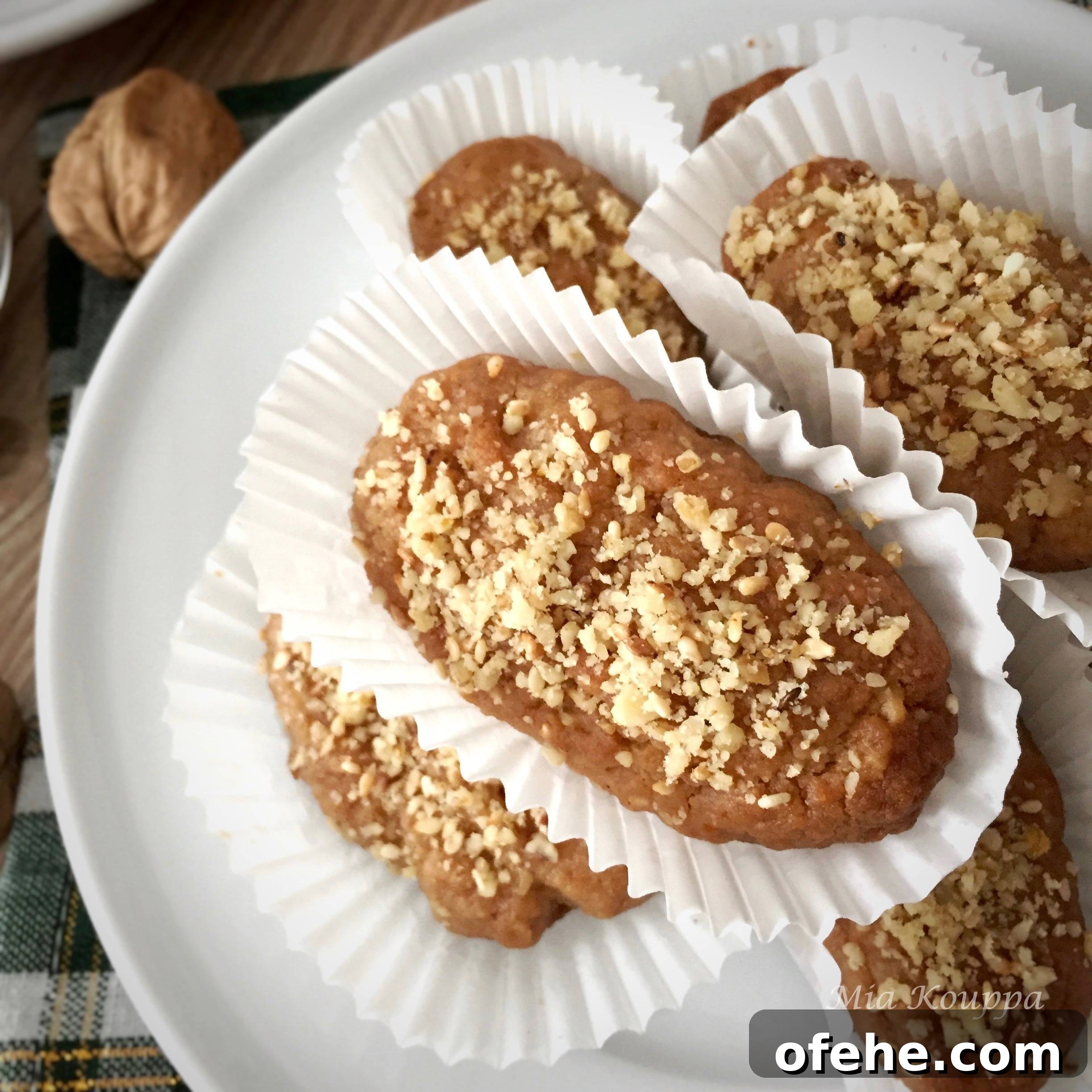 Melomakarona Greek cookies. These deliciously spiced, honey soaked, walnut topped Greek cookies just melt in your mouth.
