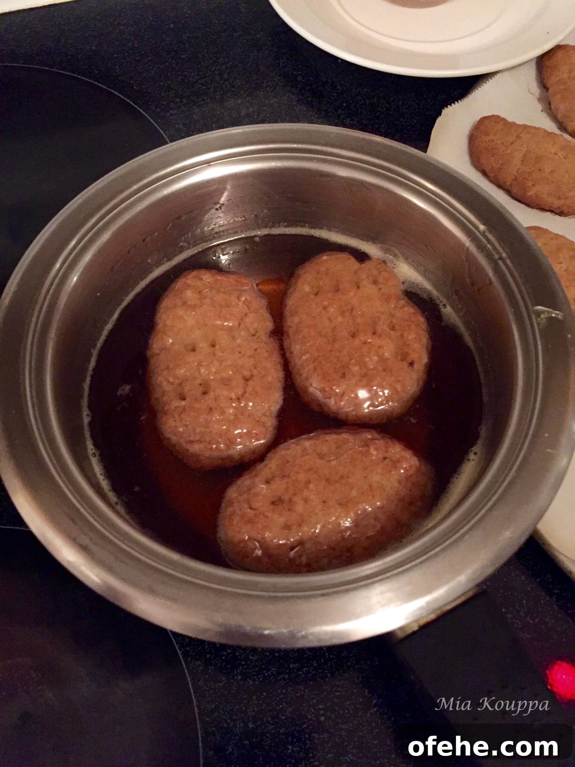 Melomakarona Greek cookies. These deliciously spiced, honey soaked, walnut topped Greek cookies just melt in your mouth.