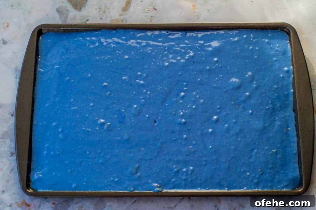 Colorful Earth Day Sheet-Pan Pancakes Recipe 11 Blue Earth Day pancake batter poured onto a prepared sheet pan.