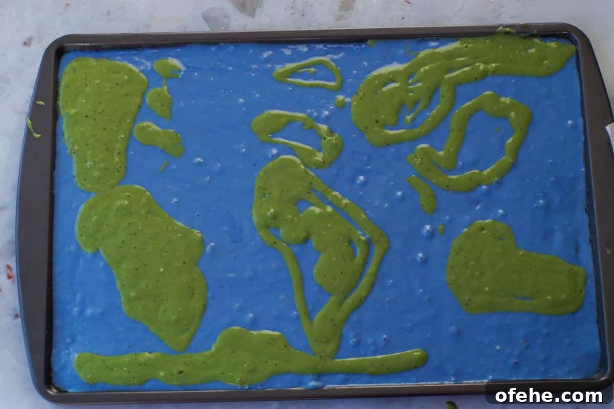 Colorful Earth Day Sheet-Pan Pancakes Recipe 13 Green matcha batter outlines of continents on the blue to look like a world map.