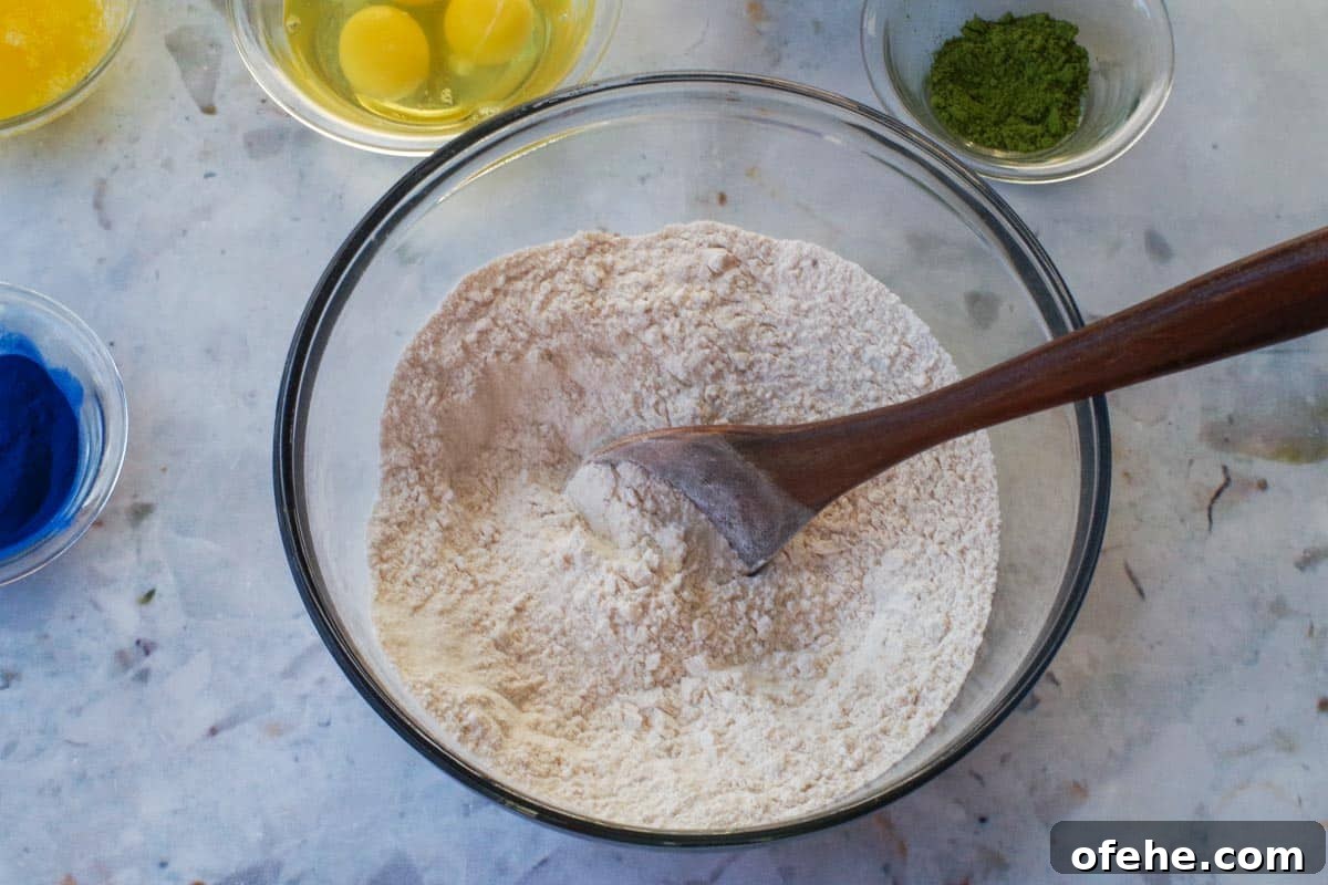 Colorful Earth Day Sheet-Pan Pancakes Recipe 4 Dry ingredients for Earth Day Pancakes being stirred together in a glass bowl.