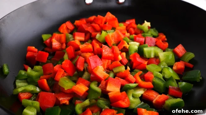 Homestyle Sweet and Sour Chicken with Tangy Pineapple Sauce 5 sautéing peppers in a large skillet