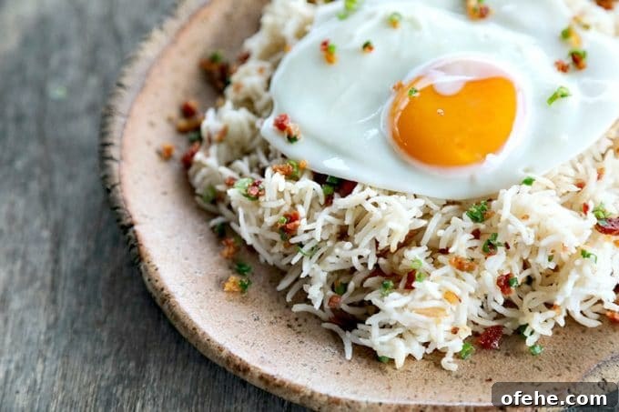 Bacon Garlic Rice; tender grains of basmati rice bursting with bacon, fried garlic, and fresh green onion. It's a flavour explosion that is great with grilled chicken, fish, beef, or pork, or nibbled straight from the fridge at midnight.