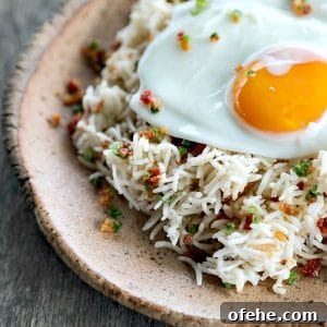 Bacon Garlic Rice; tender grains of basmati rice bursting with bacon, fried garlic, and fresh green onion. It's a flavour explosion that is great with grilled chicken, fish, beef, or pork, or nibbled straight from the fridge at midnight.