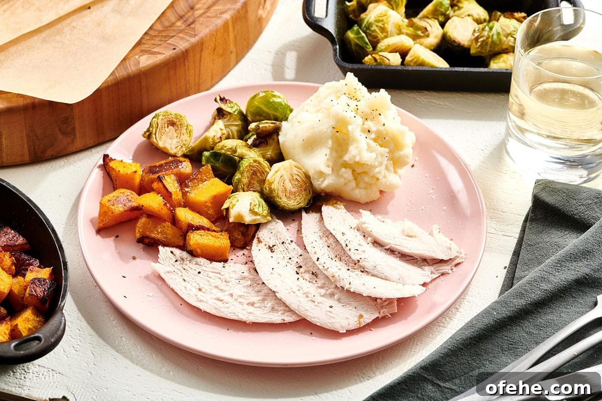 Roast Turkey Breast: Juicy Oven Method and Timing 2 Thanksgiving meal on pink plate with turkey, sweet potatoes, and Brussels sprouts.