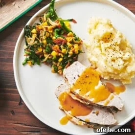 Plate with vegetables, mashed potatoes, and slices of Turkey Breast with gravy.