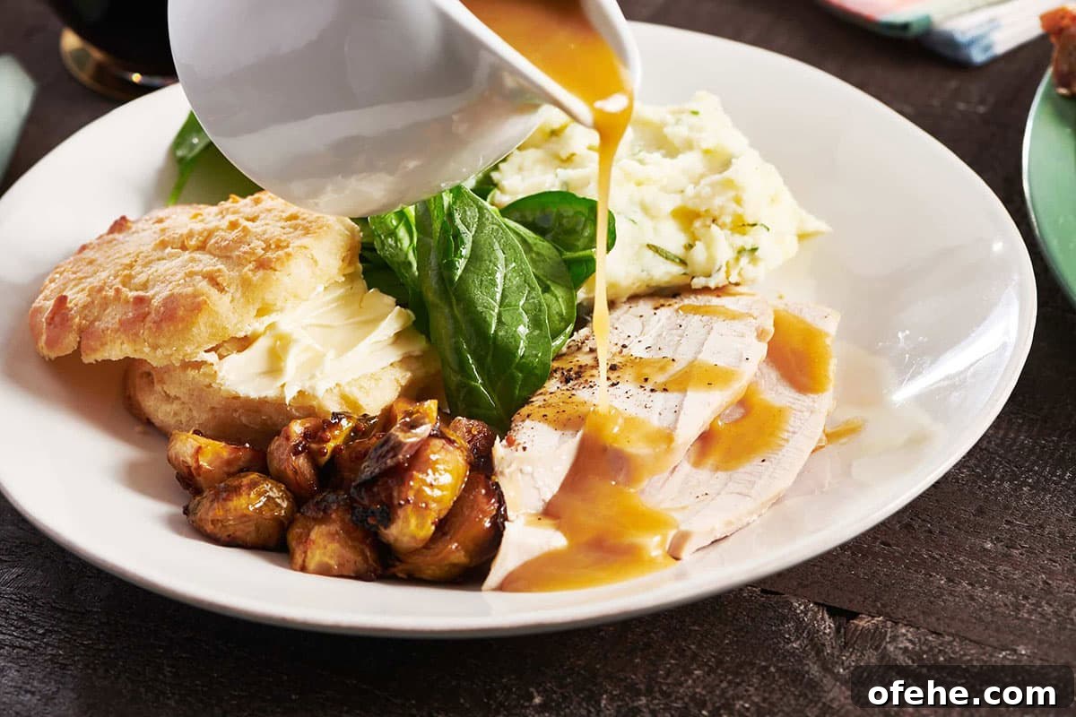 Roast Turkey Breast: Juicy Oven Method and Timing 10 Gravy boat pouring gravy over slices of turkey.