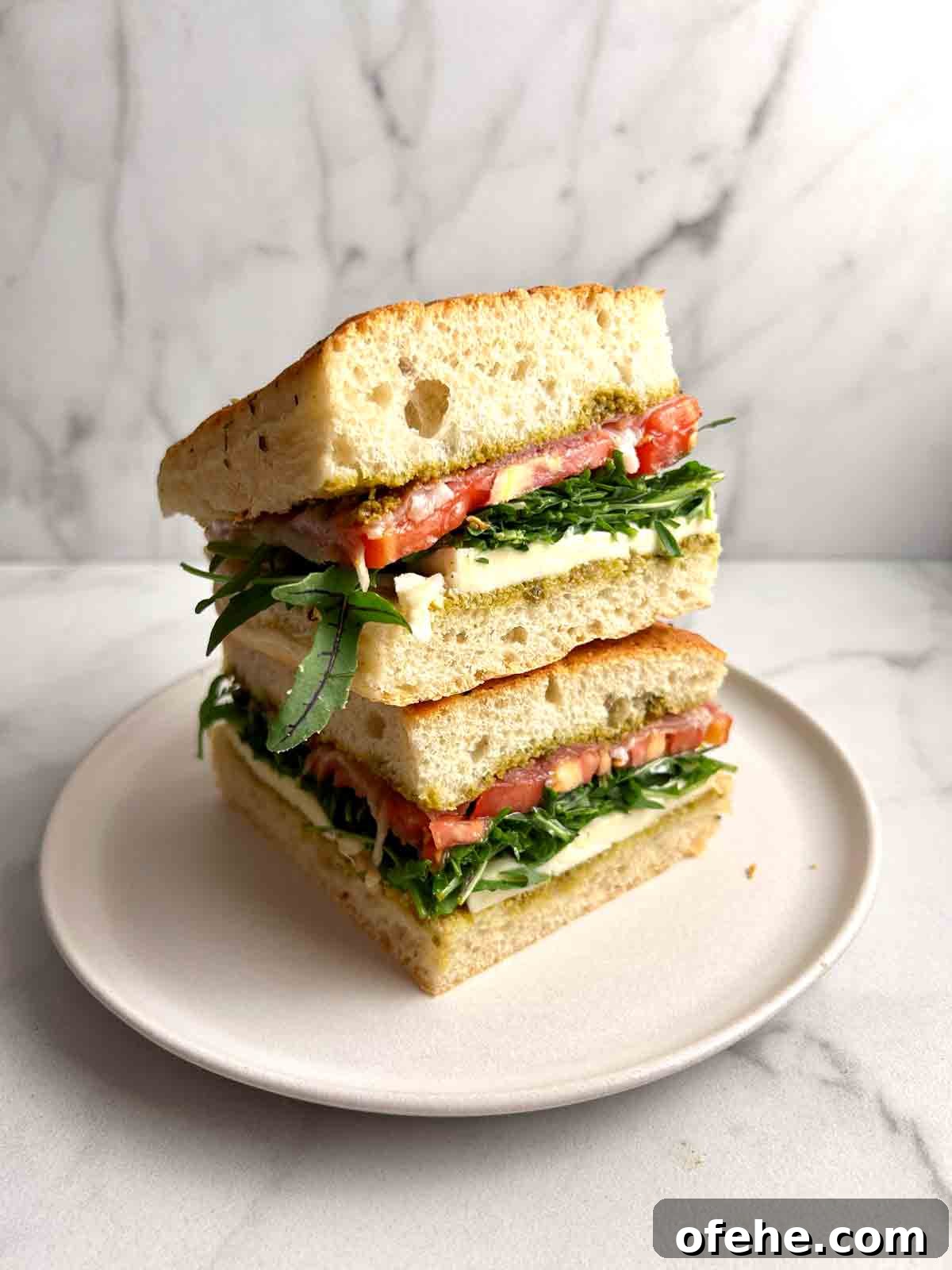 two slices of focaccia sandwich stacked on top of each other.