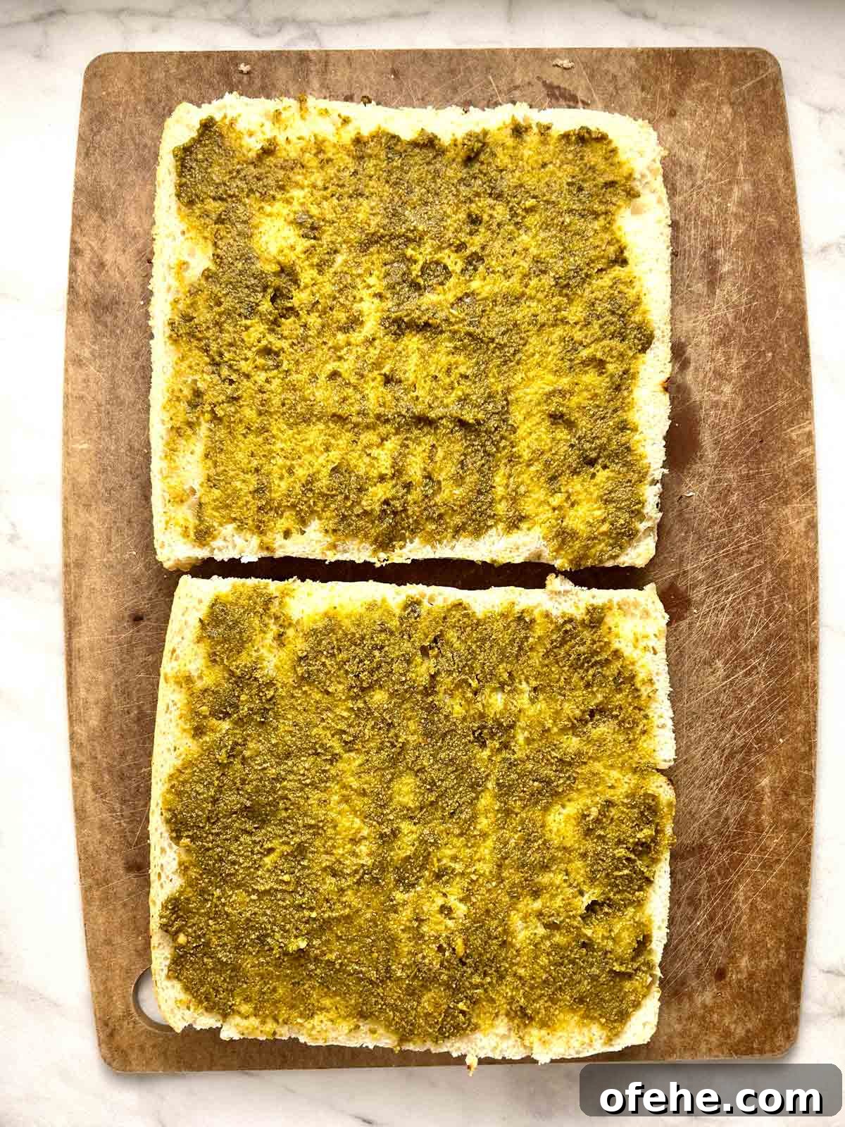 pesto spread on focaccia halves.