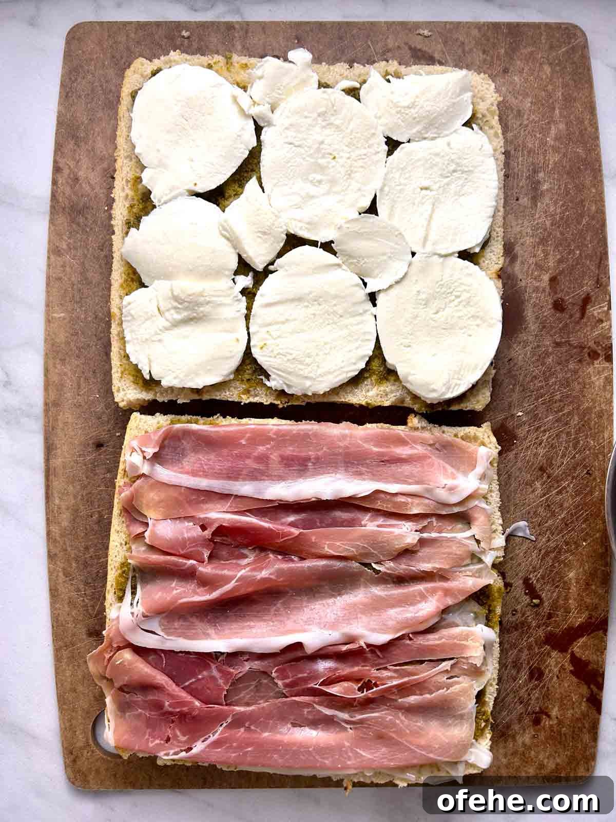 mozzarella and meat on focaccia halves.