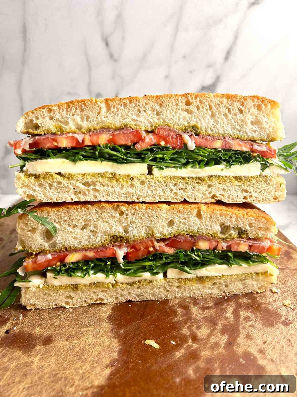 focaccia sandwich cut in half and stacked on top of each other.