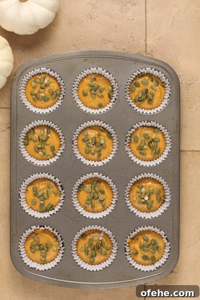 Moist Pumpkin Muffins with Warm Spices Recipe 7 Batter for pumpkin muffins divided into a lined muffin tin, ready to bake