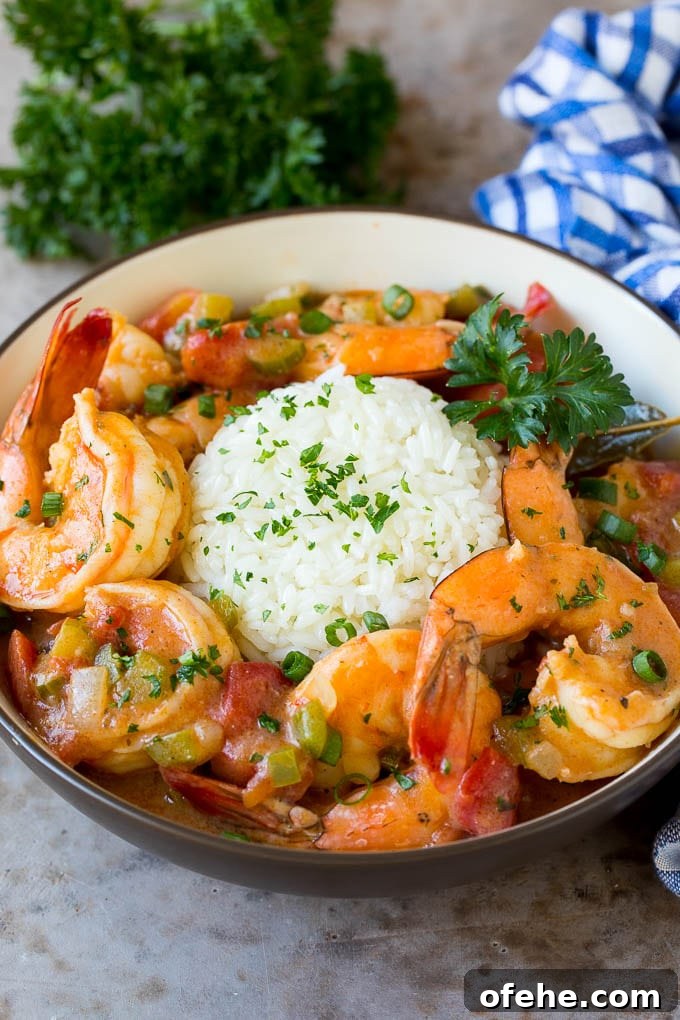 This shrimp etouffee is tender and succulent shrimp stewed with tomatoes, vegetables and seasonings. A bowl of shrimp etouffee served with rice.