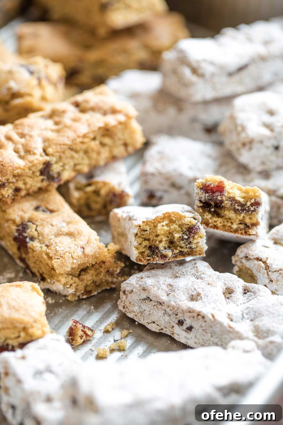 Bars in the baking pan, all moved about at different angles, and with some already dipped in sugar.