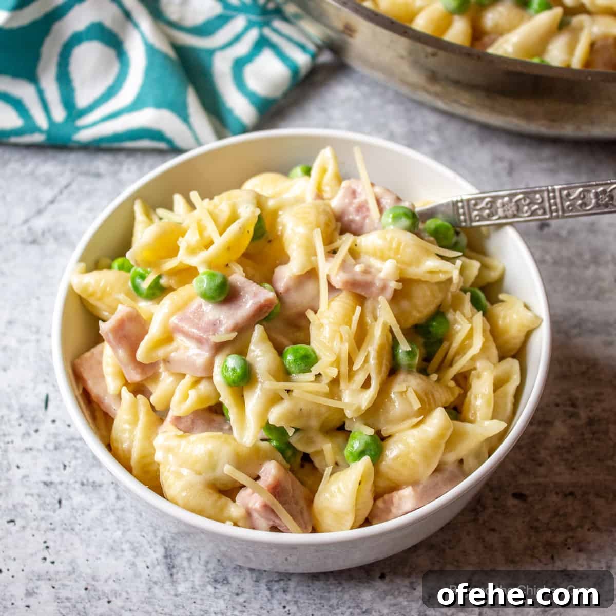 Creamy Ham and Pea Pasta Recipe for Quick Weeknight Dinners 2 A bowl filled with pasta shells with ham and peas.