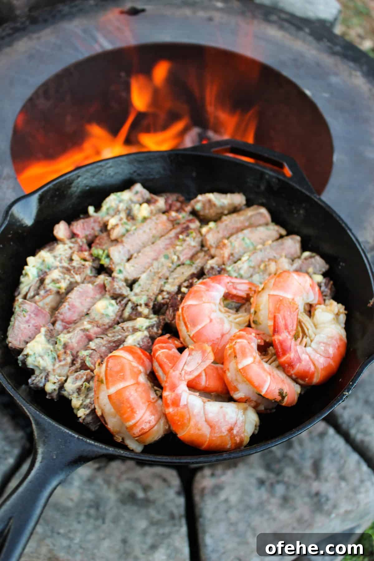 Top Surf and Turf Recipes for Dinner: Steak and Seafood Ideas 2 A cast iron pan filled with some surf and turf.