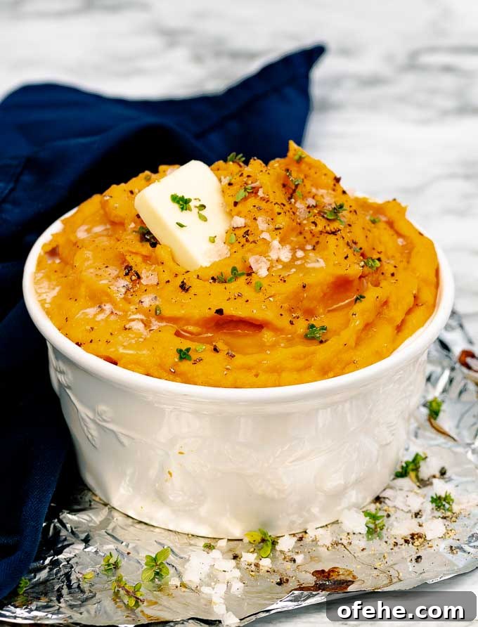 Savory Roasted Sweet Potato Mash with Garlic and Herbs 6 Roasted Savory Mashed Sweet Potatoes in a white bowl next to a blue napkin