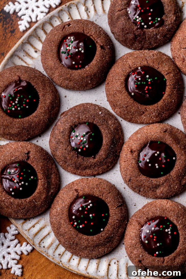 Chocolate Thumbprint Cookies with Gooey Jam Centers 8 Top view of chocolate thumbprint cookies on a plate.