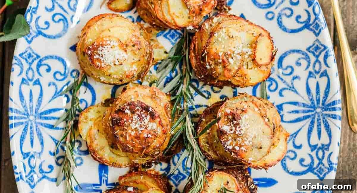 Overhead image of chipotle herbs muffin tin potatoes on white and blue dish with garnish.