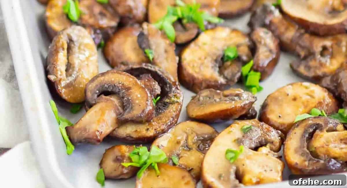 Overhead image of baked ranch mushrooms with garnish.