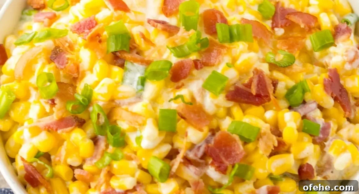 Overhead image of full loaded slow cooker cream corn with garnish.