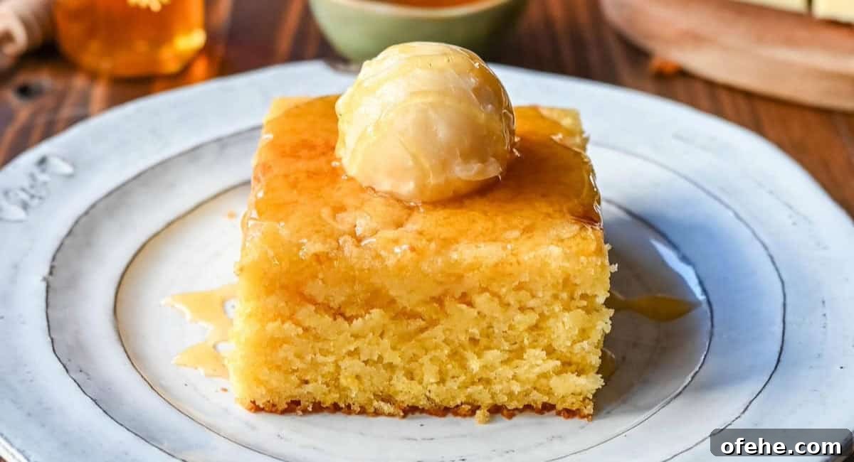 Up close image of cornbread recipe with butter topping and honey.