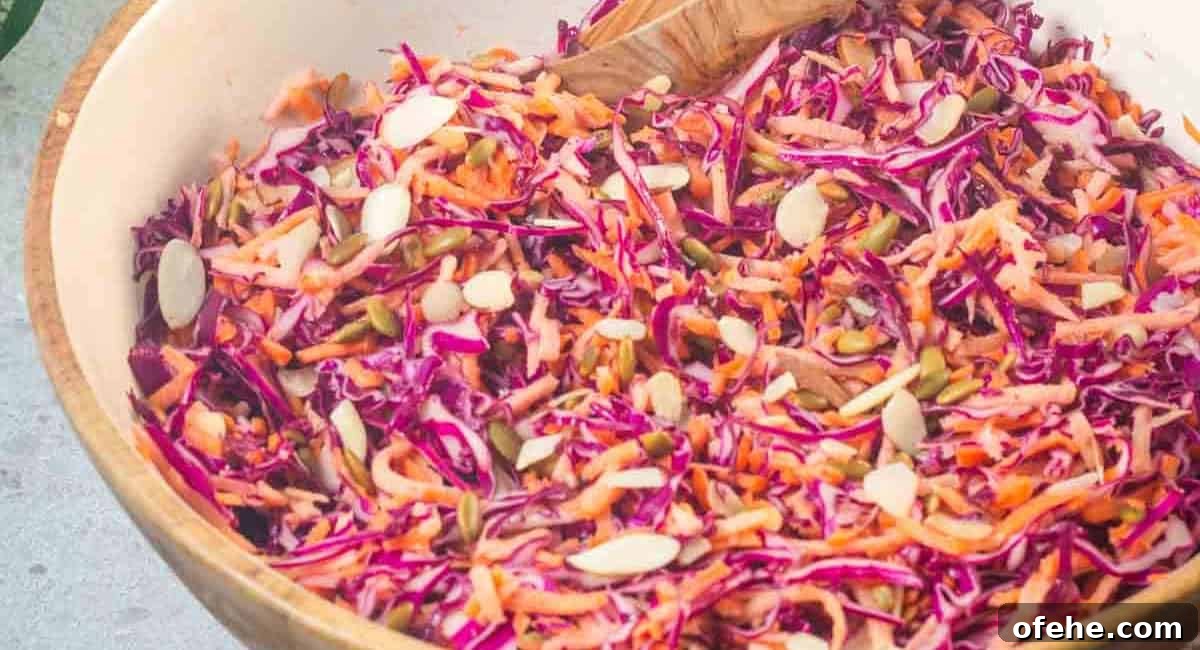Overhead image of purple cabbage and carrot coleslaw in a bowl.