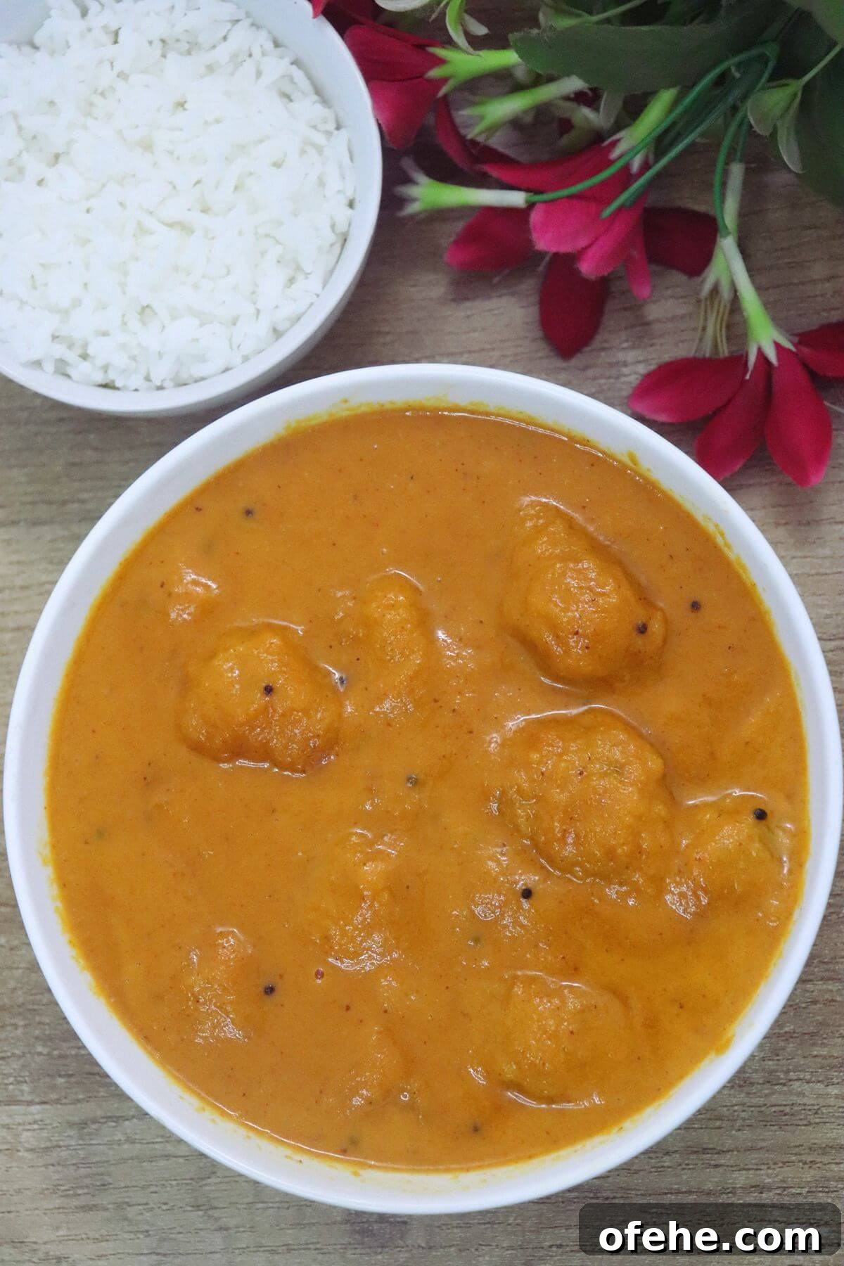 Ghotache sasav in a white bowl served with steamed rice.
