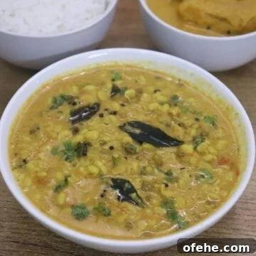 mooga gathi also known as sprouted green gram curry served in a white bowl.