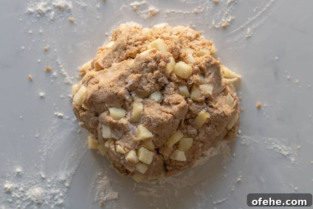 Apple Cinnamon Scones with Crunchy Cinnamon Streusel Topping 4 apple cinnamon scone dough sitting on a marble counter