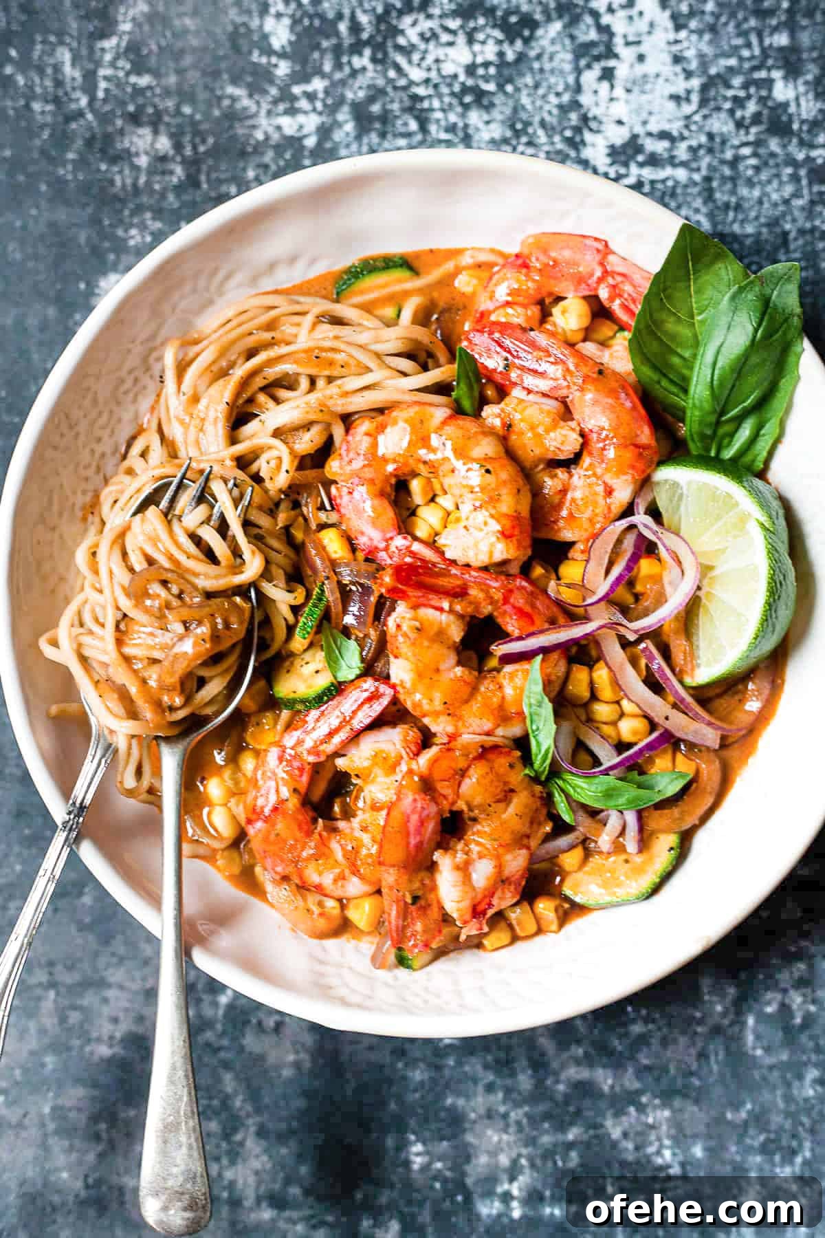 30-Minute Red Thai Prawn Curry Recipe for Busy Weeknights 2 Red Thai prawn curry with noodles and vegetables in a bowl.