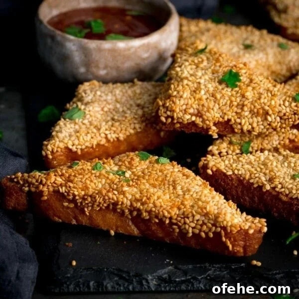 Crispy Chicken Lollipops Recipe: Finger-Licking Party Snack 9 Prawn toast on a black serving board