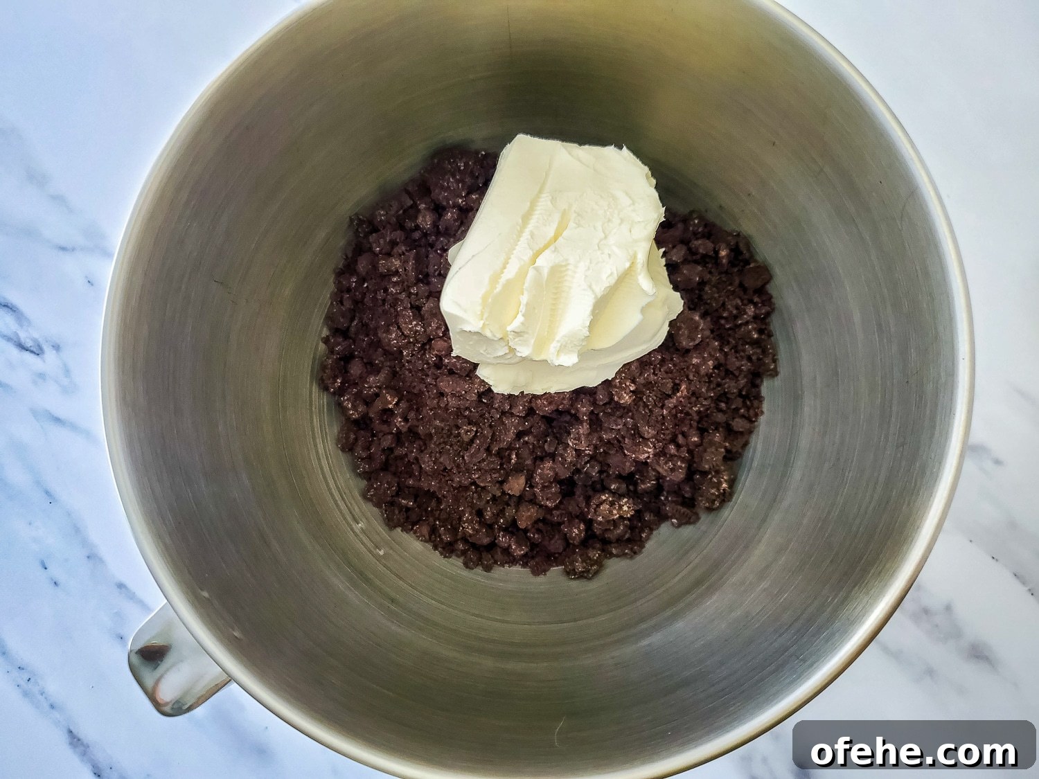 mixing cream cheese with Oreo crumbs